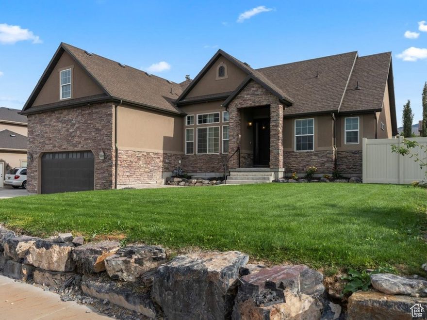 This stunning 6+ bedroom residence combines luxury, comfort, and convenience with breathtaking mountain views all around.  Located minutes from shopping, dining, golf course,  everyday amenities, and walking distance to schools, the location is as ideal as it is serene. Inside, you'll find a chef's kitchen complete with high-end stainless steel appliances, granite countertops, a spacious double fridge/freezer, and plenty of room to gather. The home's soaring ceilings, cozy fireplace, and expansive great rooms, including a massive bonus room create a warm and inviting atmosphere, perfect for entertaining or relaxing with family. The finished basement adds even more living space, featuring three additional bedrooms,  and a versatile great room that is pre-plumbed for a kitchenette. Step outside to a fully fenced backyard retreat designed for both fun and relaxation. Enjoy the in-ground trampoline, RV pad, and a pergola-covered porch with double couple's swings - all surrounded by beautiful views.  Most furniture currently in the home is negotiable and may be included in the purchase. Don't miss this opportunity to own a truly remarkable property in one of Saratoga Springs' most desirable neighborhood with a strong community feel!