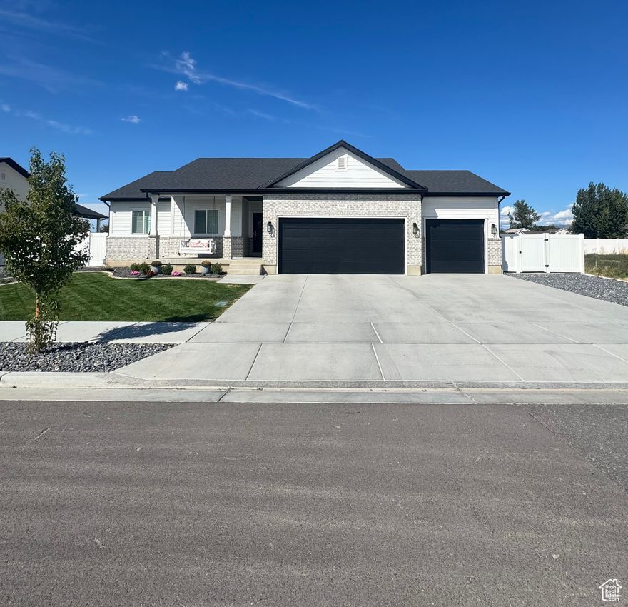 Built in 2022, this well-kept rambler offers 3 bedrooms, 2 bathrooms, and 1,475 sq. ft. on the main level, plus a full 1,363 sq. ft. unfinished basement with a large cold storage room-ready for your personal touch. The open-concept layout features a spacious living area, a cozy gas fireplace, and a modern kitchen designed for comfort and convenience. The finished 3-car garage comes with thoughtful upgrades, adding extra functionality and value. Step outside to enjoy a backyard with no neighbors behind, just peaceful farmland views. The fully fenced yard is complete with a covered patio, playset, and shed, perfect for outdoor living. Located near multiple schools and within minutes of Smith's Marketplace, this home combines quiet living with everyday convenience. Don't miss the opportunity to own a nearly new home in a fantastic location!