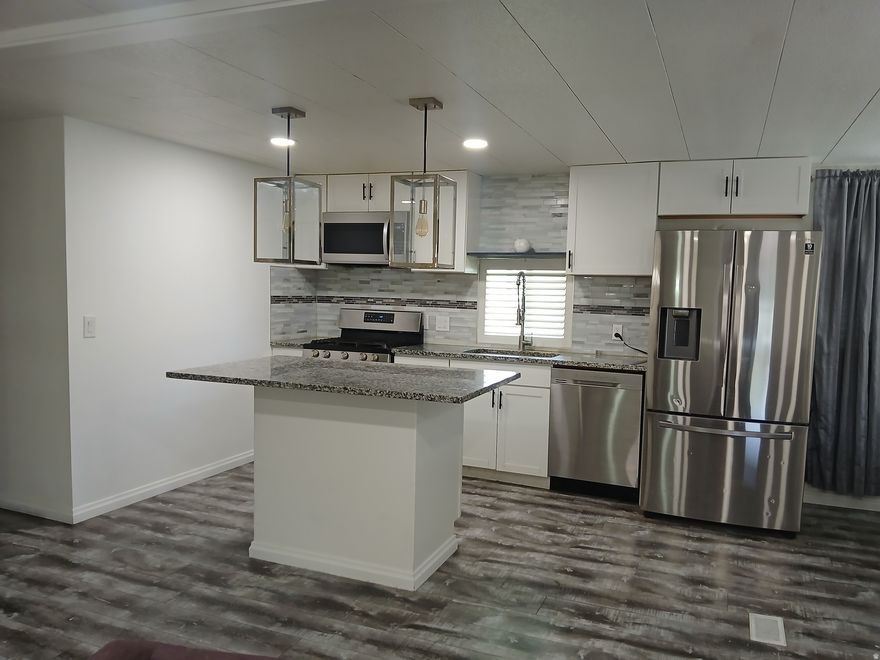 This spacious double-wide unit has been fully updated. Features include granite countertops, updated cabinets, newer appliances, LVP flooring throughout, and a refreshed bathroom. Must see.