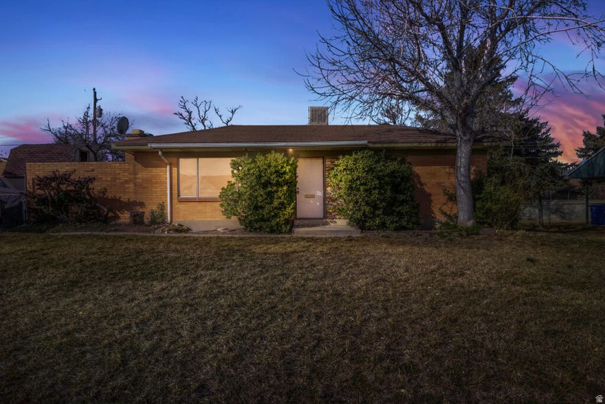 For nearly 30 years, this home has been more than just walls and a roof. It has been a place of laughter, growing families, scraped knees, school mornings, and the everyday moments that quietly shape a life. Tucked into a quiet residential neighborhood in West Valley City, this 4-bedroom, 2-bath rambler now stands ready for its next chapter.  Life brings seasons of change. After decades of love and memories, the seller is turning the page to preserve her quality of life and begin a new journey. What remains is a home filled with character, waiting for someone with vision to restore it to its full glory.  Inside, two stunning fireplaces anchor the living spaces, offering warmth and architectural charm that simply is not replicated in newer construction. The beautifully preserved tan brick masonry gives the exterior a distinctive presence that feels solid, timeless, and rich with character. In the front yard, a mature walnut tree produces an abundance year after year, a living reminder of the roots planted here long ago.  This is a fixer upper with opportunity written all over it. It is ideal for a buyer who can see beyond what is and imagine what could be. With four bedrooms, two bathrooms, and a classic rambler layout, the foundation is here. The vision is yours.  If you are looking for a home you can restore, personalize, and breathe new life into, this is your chance to honor its past while building your future.