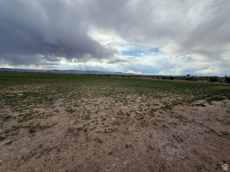 It's not every day that a farmer transforms productive alfalfa fields into a residential building lot-making this a rare opportunity! Located in peaceful Elmo, Utah, this lot is surrounded by beautiful mountain views and offers the privacy of no close neighbors. Zoned with animal rights and still capable of producing income as an alfalfa field, this property is ideal for those seeking space, serenity, and potential. Buyers looking to secure land now and build in the future-ask about financing options such as "lot loans" or "land loans" that may be available through select banks. If the Buyer takes the property out of greenbelt they will be responsible to pay the green belt back taxes. Once their is an accepted offer the Buyer will be responsible to apply for greenbelt. List price is based off of recent appraisal. Seller Finance available. Square footage figures are provided as a courtesy estimate only and were obtained from Emery County . Buyer is advised to obtain an independent measurement.