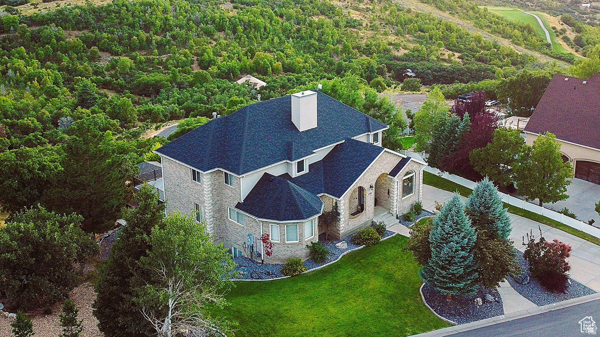 YOUR BREATHTAKING UTAH COUNTY HAVEN AWAITS. Discover an unparalleled living experience in this 5,743 sq ft custom home, nestled in a truly rare Utah County location. Prepare to be captivated by stunning, unobstructed views of Payson Canyon and Mount Nebo. THIS CAREFULLY MAINTAINED RESIDENCE boasts a new roof (2022) and a recent neutral-toned facelift with new flooring throughout. THE ENTRY and living room impress with two-story vaulted ceilings and a towering stone fireplace. The heart of the home features a spacious kitchen with granite countertops, a center island, and a butler's pantry, flowing seamlessly into a family room with stone fireplace and a dining area offering 270-degree mountain vistas. THE MAIN FLOOR offers a generous master suite with a double vanity, walk-in closet, and convenient stackable laundry. Upstairs, find four additional bedrooms, two full bathrooms, a dedicated laundry room, and a library. The finished basement provides a family room, bathroom, and a versatile multi-purpose room. STEP OUTSIDE to a $200k professionally terraced and landscaped yard, complete with a large deck, pavilion, and fire pit all designed to maximize enjoyment of the breathtaking scenery alongside family and friends. With an oversized 3-car garage and exceptional value at just $156/sq ft, this unique property offers an irreplaceable blend of luxury, location, and views. Don't miss this incredible opportunity! Buyer to verify all information. Square footage figures are provided as a courtesy estimate only and were obtained from prior MLS listings and independent measurements. Buyer is advised to obtain an independent measurement.
