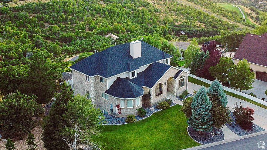 YOUR BREATHTAKING UTAH COUNTY HAVEN AWAITS. Discover an unparalleled living experience in this 5,743 sq ft custom home, nestled in a truly rare Utah County location. Prepare to be captivated by stunning, unobstructed views of Payson Canyon and Mount Nebo. THIS CAREFULLY MAINTAINED RESIDENCE boasts a new roof (2022) and a recent neutral-toned facelift with new flooring throughout.  THE ENTRY and living room impress with two-story vaulted ceilings and a towering stone fireplace. The heart of the home features a spacious kitchen with granite countertops, a center island, and a butler's pantry, flowing seamlessly into a family room with stone fireplace and a dining area offering 270-degree mountain vistas. THE MAIN FLOOR offers a generous master suite with a double vanity, walk-in closet, and convenient stackable laundry. Upstairs, find four additional bedrooms, two full bathrooms, a dedicated laundry room, and a library. The finished basement provides a family room, bathroom, and a versatile multi-purpose room. STEP OUTSIDE to a $200k professionally terraced and landscaped yard, complete with a large deck, pavilion, and fire pit  all designed to maximize enjoyment of the breathtaking scenery alongside family and friends. With an oversized 3-car garage and exceptional value at just $156/sq ft, this unique property offers an irreplaceable blend of luxury, location, and views. Don't miss this incredible opportunity!    Buyer to verify all information. Square footage figures are provided as a courtesy estimate only and were obtained from prior MLS listings and independent measurements.  Buyer is advised to obtain an independent measurement.