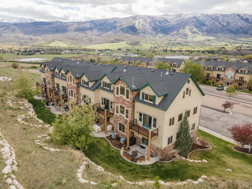 Stunning mountain-modern end-unit luxury condo in the Ogden Valley @ Wolf Creek Resort - a rare find that blends upscale living with easy year-round access to outdoor adventures. This three-bedroom, 3.5-bath retreat is ready for full-time residence or a high-demand rental investment, with exceptionally light-filled interiors and a near-new condition thanks to limited owner use.  Key features - End-unit with abundant natural light and a clean, modern aesthetic - Three bedrooms on the lower level, each with its own full bath (perfect for guests) - 3.5 baths in total - Deluxe kitchen with granite countertops and stainless steel appliances - Excellent condition with minimal owner wear; feels like new - Dedicated storage closet in the building lobby - Patio and deck extend entertaining space into the grand outdoors - truly Eden - Community Amenities include Heated Pool, 2 Hot Tubs, Gym, Club House, Sauna, Walking Trails   Location highlights - Adjacent to Wolf Creek Golf Course and the Powder Mountain ski shuttle - Panoramic views of Pineview Lake, Nordic Valley, Snowbasin, surrounding mountains, and the Ogden Valley - Just 15 miles from Ogden; minutes to boating, skiing, biking, hiking, cross-country skiing, golfing, and more  Why this is a must-see - Versatile living: ideal as a full-time residence or a lucrative rental investment - Low-maintenance luxury with easy access to outdoor recreation year-round - Easy to show and ready for you to move in.  This one won't last. For a viewing, contact your agent today to schedule a tour and see why this end-unit condo is the premier choice in the Ogden Valley.