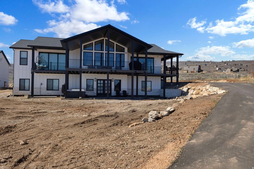 Turnkey luxury Bear Lake retreat built by a custom home builder and only a few months old. Sold fully furnished with over $100K in high-end furnishings, plus a new hot tub included. Walk in and be wowed. Exceptional finishes and quality craftsmanship throughout, this home is designed for both comfort and strong rental potential. The bright open-concept layout features upscale materials, expansive gathering spaces perfect for entertaining, and a premium sound system. Huge windows frame stunning lake views while filling the home with natural light. Multiple spacious bedrooms and inviting living areas accommodate large groups, making it ideal as a vacation home or short-term rental.Everything in the home stays with the exception of the ATV and jet skis in the garage. Located in a premier year-round recreation area with easy access to boating, beaches, trails, and winter activities.Oversized garage offers abundant space for boats, ATVs, and outdoor equipment. Ideal as a private getaway, investment property, or combination of both. See attached builder floor plans. Buyer to verify all information.