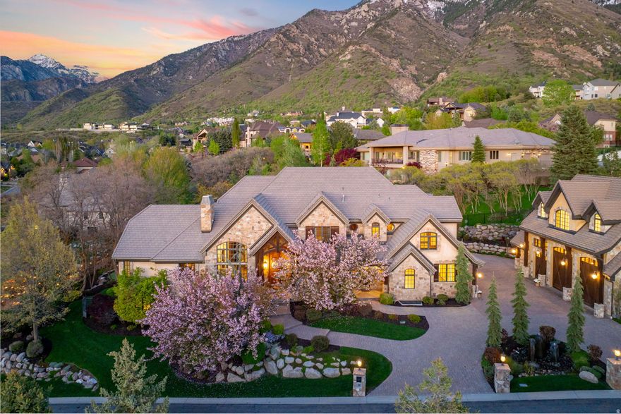 Experience the pinnacle of luxury living in this extraordinary estate located in the prestigious, 24-hour guard-gated Pepperwood community. Expertly crafted with exceptional attention to detail, the home showcases soaring ceilings on every level, expansive mountain views, and oversized windows that flood the interior with natural light-creating a seamless indoor-outdoor connection. Most bedrooms feature private en-suite bathrooms, offering comfort and privacy throughout. The spacious main-level primary suite is a true retreat with a spa-like bathroom and generous walk-in closet. Designed for entertaining, the gourmet kitchen anchors the home, while the walkout basement delivers unmatched amenities including a second full kitchen, theater room with screen and recliners, golf simulator, craft room, commercial-style gym, and an impressive indoor basketball court complete with observation room and wet bar. A secure underground walkway leads to the detached garage, bringing the total to seven heated garage bays-ideal for car enthusiasts or recreational storage. Above the garage sits a fully finished apartment with a bedroom, en-suite bath, and additional half bath, perfect for guests, extended family, or a private office. The backyard is a year-round oasis featuring a swimming pool with slide, in-ground trampoline, putting green, playhouse, and a built-in BBQ with full outdoor kitchen. The spacious patio offers ideal afternoon shade for summer entertaining. Pepperwood residents enjoy resort-style amenities including a pool and hot tub with lifeguards, competitive swim team, tennis, pickleball and volleyball courts, a newly upgraded playground, and miles of scenic walking and biking trails-all just minutes from world-class skiing in Little Cottonwood Canyon, top-rated schools, and premier shopping and dining.  Square footage figures are provided as a courtesy estimate only and were obtained from County Records .  Buyer is advised to obtain an independent measurement.