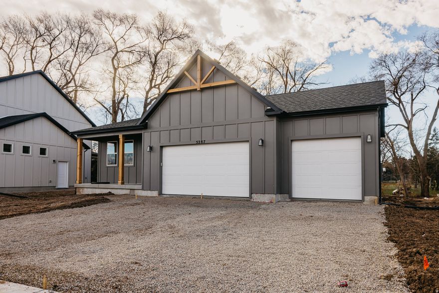 !!$40,000 in FREE BASEMENT INCENTIVE + 2-1 BUY DOWN!! Set within a premier golf-course community, just steps from the manicured greens of Schneiter's Riverside Golf Course, The Abbey at Riverside Estates offers nearly 3,000 square feet of refined, thoughtfully designed living space. This beautifully appointed home showcases a timeless farmhouse elevation with full Hardie siding, delivering both striking curb appeal and enduring quality.  Inside, the grand living area is filled with natural light, enhanced by expansive windows and a sliding glass door that seamlessly connects indoor and outdoor living. The heart of the home is the elevated gourmet kitchen, featuring quartz countertops, a designer tile backsplash, and an impressive 7' x 3' island with integrated sink-perfect for gathering and entertaining. Soft-close cabinetry with dovetail construction, paired with a Whirlpool fingerprint-resistant gas appliance package, brings both luxury and everyday functionality to the space.  Designed for comfortable main-level living, the home offers a serene owner's suite retreat, complete with a spa-inspired walk-in shower, upgraded glass enclosure, and double-sink vanity. In total, the home features five spacious bedrooms and three full bathrooms, providing flexibility for guests, home offices, or multigenerational living.  The fully finished basement, enhanced by a 9-foot foundation wall upgrade, expands the living space with a generous recreation room, additional bedroom and bathroom, and ample storage-ideal for entertaining, relaxing, or hosting overnight guests. A smart TV wiring package ensures the home is equipped for modern living and elevated entertainment.  Blending thoughtful design, quality craftsmanship, and an exceptional golf-course-adjacent location, The Abbey at Riverside Estates delivers a rare opportunity to enjoy both luxury and lifestyle in one of Riverdale's most desirable communities. Photos represent the same floor plan and may not reflect the exact finishes of this home. Schedule your private showing today and ask about exclusive preferred lender incentives.