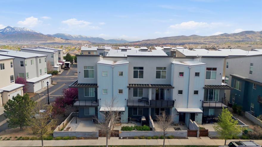 This 2014-built townhome offers a layout that truly works for real life, with a rare main-level bedroom on the first floor, perfect for guests, a home office, or added flexibility. As you head upstairs, the main living level opens up beautifully with 9-foot ceilings, oversized windows, and natural light pouring in from every angle. The kitchen is the heart of the home, featuring a spacious island that flows seamlessly into the living and dining areas. Step out onto your private balcony and take in the unobstructed views of the Oquirrh Mountains... It's the kind of view that never gets old. Upstairs, you'll find three additional bedrooms, including a standout primary suite with 12-foot ceilings, an oversized walk-in shower, and a generous walk-in closet. It's the kind of space that feels both open and relaxing at the same time. With two bathrooms upstairs and a convenient half bath on the main level, the layout is both functional and comfortable. Out front, you have your own fenced patio space, perfect for summer BBQs, morning coffee, or just enjoying a little outdoor privacy. And the location? It's exactly where you want to be. Situated in the heart of Herriman, you're just minutes from Lynn Crane Park, the rec center, library, shopping, and dining. Most daily essentials are within about a mile, making everyday life that much easier. Plus, with multiple parks, golf courses, and outdoor recreation nearby, you get the best of both convenience and lifestyle. This isn't just a townhome, it's a space that lives well, in a location that makes sense.   Square footage figures are provided as a courtesy estimate only. Buyer is advised to obtain an independent measurement.