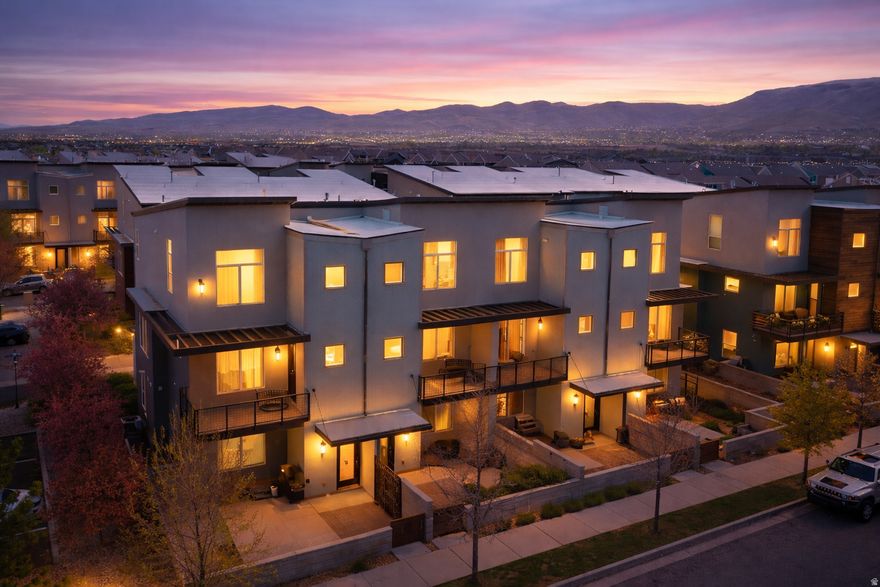 This 2014-built townhome offers a layout that truly works for real life, with a rare main-level bedroom on the first floor, perfect for guests, a home office, or added flexibility. As you head upstairs, the main living level opens up beautifully with 9-foot ceilings, oversized windows, and natural light pouring in from every angle. The kitchen is the heart of the home, featuring a spacious island that flows seamlessly into the living and dining areas. Step out onto your private balcony and take in the unobstructed views of the Oquirrh Mountains... It's the kind of view that never gets old. Upstairs, you'll find three additional bedrooms, including a standout primary suite with 12-foot ceilings, an oversized walk-in shower, and a generous walk-in closet. It's the kind of space that feels both open and relaxing at the same time. With two bathrooms upstairs and a convenient half bath on the main level, the layout is both functional and comfortable. Out front, you have your own fenced patio space, perfect for summer BBQs, morning coffee, or just enjoying a little outdoor privacy. And the location? It's exactly where you want to be. Situated in the heart of Herriman, you're just minutes from Lynn Crane Park, the rec center, library, shopping, and dining. Most daily essentials are within about a mile, making everyday life that much easier. Plus, with multiple parks, golf courses, and outdoor recreation nearby, you get the best of both convenience and lifestyle. This isn't just a townhome, it's a space that lives well, in a location that makes sense.   Square footage figures are provided as a courtesy estimate only. Buyer is advised to obtain an independent measurement.