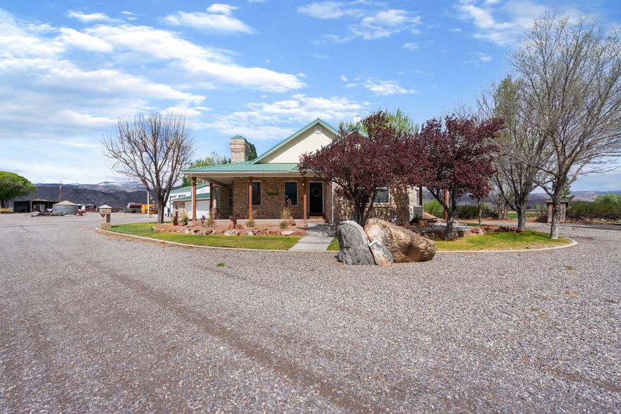 This exceptional property is perfectly set up for horses and country living. The 21+ acres feature a 115'x200' arena, horse corrals, stalls, hay barn, tack shed, 10 shares of water, and multiple outbuildings-offering everything needed for a turnkey operation. The well-maintained all-brick home was built with quality and longevity in mind, featuring a durable metal roof and a charming wrap-around porch to take in the peaceful surrounding views.  The spacious 42' x 56' shop provides plenty of room for hobbies or equipment and includes dedicated office space that could be converted into an apartment or used for a home-based business. With ample space for livestock, equipment, and recreation, this property offers the ideal blend of functionality and comfort for equestrian enthusiasts or anyone seeking a rural lifestyle.