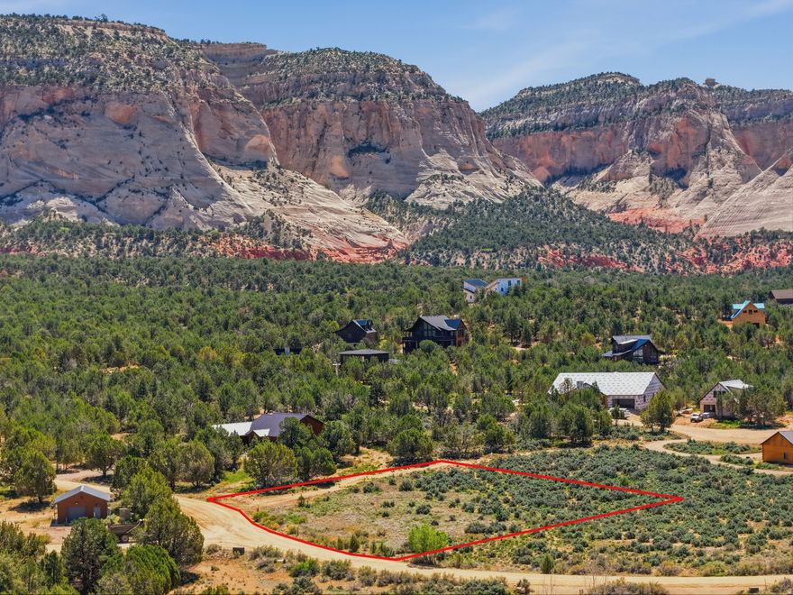 Discover an exceptional opportunity to create your dream cabin retreat within the exclusive Quarter Circle H Subdivision. This elevated 1.05 acre homesite is surrounded by pristine natural terrain, offering a rare blend of privacy, tranquility, and unobstructed beauty. Enjoy breathtaking 360-degree views-from the striking White Cliffs to sweeping valley vistas, perfectly positioned for a custom build that captures the scenery from every angle. With year-round access and short-term rentals (Airbnb/VRBO) permitted, this property offers both convenience and investment potential. Protective covenants (CC&Rs) are in place to preserve the area's peaceful, country-living atmosphere while still being within reach of modern amenities. Ideally located just 20 minutes from Zion National Park, 1 hour from Bryce Canyon National Park, 20 minutes from Coral Pink Sand Dunes, and near Best Friends Animal Society-this is your opportunity to own a piece of Southern Utah's incredible landscape. (Buyer to verify all)