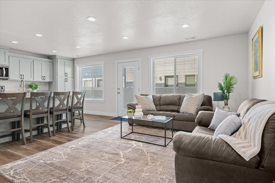 This stunning townhouse is perfectly situated within walking distance of Roy Station, making it an ideal choice for commuters. With the FrontRunner train, you can be in downtown Salt Lake City or at the airport in about an hour, offering unparalleled convenience for work or travel. The fully finished basement is a standout feature of this home, offering a sizable living room perfect for entertaining or relaxing. It also includes a full bathroom and an additional bedroom, making it an excellent space for guests. Ample storage closets ensure that all your belongings have a place, keeping your home organized and clutter-free. The main level boasts an open floor plan that is both inviting and functional. The kitchen is beautifully finished with granite countertops and offers plenty of space and storage options. A mudroom conveniently situated next to the two-car garage provides a practical entryway for daily life. Additionally, a half bath on this level adds to the home's convenience. Upstairs, you will find three comfortable bedrooms. A full bathroom serves the additional bedrooms, ensuring plenty of space for everyone. The primary bedroom is a retreat in itself, featuring an en suite bathroom with a luxurious separate tub and shower. The walk-in closet offers ample space for your wardrobe, adding to the suite's allure. With built-in Century Link, motion lights in the garage, impressive soundproofing, a shaded patio, and Walmart going in nearby, this townhouse combines modern living with convenience and style. Schedule your private tour today! Square footage figures are provided as a courtesy estimate only and were obtained from county records. Buyer is advised to obtain an independent measurement.