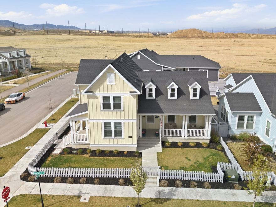 This stunning residence in the heart of Daybreak's Upper Villages offers the perfect blend of modern farmhouse design and functional luxury. Situated on a spacious corner lot, the Clearwater Farmhouse II floor plan by Destination Homes delivers an open, airy feel with soaring vaulted ceilings and designer beam accents. The gourmet kitchen serves as the centerpiece, featuring high-end cabinetry, sleek countertops, and a layout that flows effortlessly into the family room-ideal for hosting gatherings. For those who work from home, the dedicated main-floor office provides a quiet retreat with its own private exterior entrance, offering a professional touch for client meetings or a peaceful workspace. Main Level: Includes a sprawling primary suite with a spa-like bathroom and a walk-in closet, plus a spacious mudroom to keep the home organized. Upstairs: Three additional bedrooms provide plenty of room for family or guests. Basement: The massive basement offers over 2,000 sq. ft, one large bedroom, game room , theater space (TVs are included) large storage areas  The oversized 3-car garage is a hobbyist's dream, featuring extended height, extra depth, and professional epoxy flooring. Located just blocks from the upcoming Watercourse, this home places you minutes from Aspen Elementary, neighborhood parks, pickleball courts, and local coffee shops. Enjoy the signature Daybreak lifestyle with miles of trails, community pools, and beautiful mountain views right from your front door.