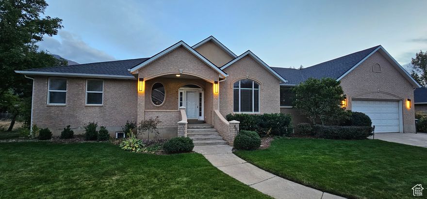 This home presents an exceptional opportunity to live in a desirable East Mapleton neighborhood. Situated on a tranquil street, the expansive .34-acre lot features impressive mountain views. Offering 4,489 square feet of finished living space, this home features six bedrooms, four full bathrooms, and a half bathroom, presenting extensive flexibility for customization. The main level welcomes you with airy 9-foot ceilings, a primary suite, sunlit open-concept kitchen, nook, and family room, a dedicated office and sunroom, additional bedroom, and bathroom. Complementing these areas, the formal dining and living rooms offer versatile spaces suitable for both everyday life and special occasions. The lower-level walkout apartment offers a thoughtfully designed living space with its own private entrance, kitchen, living room, dining area, bedroom, full bathroom, and walk-in closet. For added versatility, double doors seamlessly connect the apartment to the large family room and the remainder of the lower level, creating a flexible environment that can be tailored to suit a wide range of needs. Ideal for rental income or multi-generational accommodations. Step out onto the large deck, perfect for outdoor dining and entertaining while enjoying the beautiful views. The property includes a small, well-established orchard, a garden area ready for your favorite vegetables and flowers, and thriving grapevines and berry bushes, offering a bounty of fresh produce throughout the season. Pressurized irrigation and Mapleton Irrigation serves the property, ensuring reliable access to water. The oversized 735 square foot garage has space for a workshop and to store all the gear and equipment for your family. The house is equipped with a standby generator and a 250-gallon propane tank.