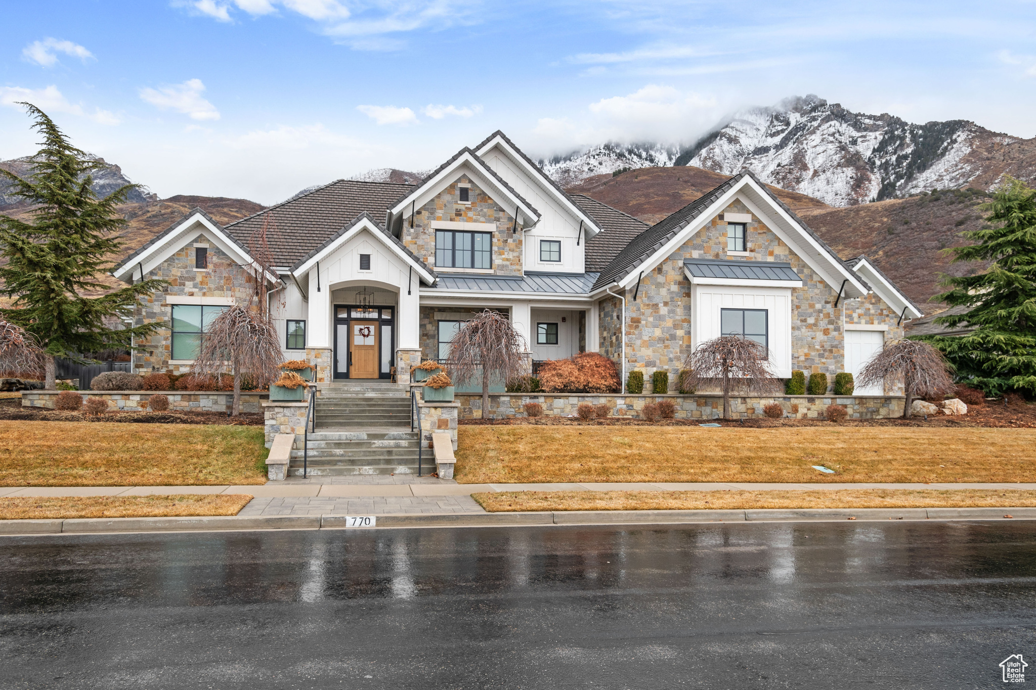 Situated in a prestigious Alpine, Utah neighborhood, this extraordinary 2016 Parade of Homes estate, built by McEwan Custom Homes, offers the ultimate in luxury living and entertainment. Spanning an impressive 15,611 square feet, this fully finished home features five spacious bedrooms, three full bathrooms, three three-quarter bathrooms, and two half bathrooms, providing ample space and comfort for family and guests. Sitting on nearly an acre of beautifully landscaped property, the home boasts breathtaking views of both the surrounding mountains and Utah Valley.  Designed with both relaxation and recreation in mind, the home includes unique features like a private two-lane bowling alley, a rock climbing wall, and a cozy fire pit, making it an entertainer's paradise. The state-of-the-art home theater is perfect for watching the latest box office hits or catching the big game in style. Custom upgrades and high-end finishes are found throughout, showcasing exceptional craftsmanship and attention to detail. The exterior features beautiful stonework and a durable concrete tile roof, adding to the home's timeless elegance.  The outdoor living space is equally impressive, with a heated pool and hot tub flanked by a 1,200-square-foot cabana that includes its own fully equipped kitchen, bathroom, shower, and a waterslide leading directly into the pool. For the boating enthusiast, the home features a dedicated boat garage measuring 31' 5.5" deep with a 12' x 12' door, alongside a four-car garage complete with an electric car charging station. Music lovers will appreciate the dedicated music room, perfect for jamming with friends or performing for family gatherings.  This home also includes a state-of-the-art home gym, designed to meet all your fitness needs without ever leaving the comfort of your own space. Paired with the indoor sauna, it creates a complete wellness retreat, allowing you to work out, unwind, and recharge all under one roof.   With its combination of luxurious amenities, custom design, and stunning views, this home is a rare gem in one of Alpine's most sought-after neighborhoods.  Square footage figures are provided as a courtesy estimate only and were obtained from builder house plans.  Buyer is advised to obtain an independent measurement.