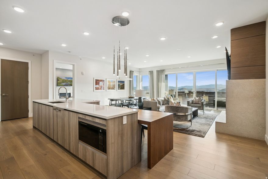 Enjoy this premiere location in Canyons Village with true ski-in, ski-out access to not one but three lifts, right from your door. This 4-bedroom, two level residence at Apex Residences redefines modern mountain living with sleek design, generous spaces, and effortless luxury. The floor-to-ceiling windows offer sweeping mountain views of the Wasatch and Uintah Mountain Ranges, as well as slope side resort surroundings. The open main living area is perfect for entertaining or unwinding after a day on the slopes, with a large deck to enjoy the outdoor atmosphere. Also located on the main level is the primary suite with fireplace and a luxurious primary bath. The lower level has a separate family room, that provides a cozy retreat for family gatherings, along with three additional bedrooms, and a second deck with a private hot tub. Every surface has been thoughtfully curated with custom wall coverings, custom drapery, motorized blinds, and high-end finishes throughout.  Owners enjoy exclusive access to world-class amenities, including a 5,000-square-foot clubhouse featuring a heated pool, hot tub, fitness center, owner's lounge, treatment rooms, and an event kitchen.   Furnishings can be purchased separately. Begin enjoying your mountain retreat right away!