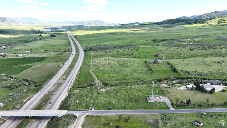 Adjacent to I-15 at Malad Summit with Creek & 3-Phase Power - Investment opportunity adjacent to I-15 with off ramp access - Potential rural residential subdivision development opportunity  - Year-round access and three phase power with 424+- feet of frontage - Adjacent to Malad Summit South Subdivision - Weather station located at summit with cameras providing Idaho DOT travelers information - Private access dirt and gravel road with utility trenched - Fenced and gated - Fiber Optics available - Year-round creek with fishing hole - Spawning ground for trout, bass and salmon - Seasonal Bissell Creek drainage - High visibility Investment opportunity adjacent to Malad Summit South Subdivision and I-15 with convenient off ramp access. Boasting year round access and available three phase power along approximately 424 feet of county paved road frontage, the property offers limitless potential as a rural residential subdivision, homestead or recreational retreat.  Surrounded by canyons, reservoirs, and creeks for outdoor recreation, yet accessibility and the benefit of Idaho DOT cam for eyes on the weather as well as cell coverage makes this property a rare find.  An Idaho DOT weather station with live cameras is located at the summit, serving as a critical asset for regional travel updates.  A cell tower leases half an acre of ground in the northwest corner of the property and sits on a 50' x 50' pad delivering comprehensive coverage over the summit.  Fiber optics connectivity is also available on the property.  A private dirt and gravel road leads into the property, with utilities already trenched. The parcel is currently zoned agricultural, and it is fenced and gated and suitable for horses or livestock with potential stock water rights to the creek.  The level to gradual sloping terrain, with small draws, offers panoramic mountain and valley views, perfect for homesites or recreational use. Bring your plans and build the home or cabin of your dreams and enjoy proximity to the Caribou National Forest.  Nature lovers and outdoor enthusiasts will be drawn to the property for the recreational opportunities.  Enjoy wildlife viewing and fishing right in your own backyard.  Bissell Creek Drainage runs in the spring near the southern end of the property and attracts wildlife such as elk, mule deer, moose, whitetail deer, coyotes, upland game and even an occasional mountain lion.  Devil's Creek is fed by spring water higher on the mountain and runs through the property year-round providing spawning ground and a fishing hole with the opportunity to catch trout, bass and salmon.  So, grab your rod and reel and set up camp right on your property.   The nearby Caribou National Forest and BLM ground offer hundreds of miles of trails and dirt roads to explore jeep-riding, 4-wheeling, mountain biking, hiking,  backpacking, camping, hunting and scouting for elk, mule deer, whitetail deer, moose, mountain lion, coyote and upland game  Explore Four-Mile Canyon, East Cherry Creek Cliffs, The Elkhorn Mountains, New Canyon and Cherry Creek Trailhead and Gardner Canyon.  For the fishing enthusiast, there are three reservoirs close to Malad City that are stocked by Idaho Fish and Game and allow for summer and ice fishing:  Deep Creek, Devil Creek, and Crowther's Reservoir.  Other reservoirs near Malad are Daniels Reservoir, Weston Reservoir and Pleasant View Reservoir.