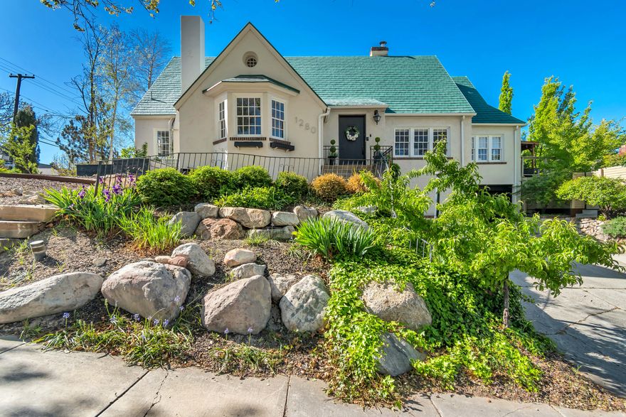 Set on sought- after Laird Avenue in the heart of Harvard & Yale, this 1923 Tudor offers a strong combination of original character, functional updates and future potential. The street itself is one of the area's most desirable-quiet, established, and highly walkable areas of SLC. Inside, a thoughtful balance of preserved details and practical improvements creates a space that feels distinctive. Hardwood flooring, high ceilings, and original design elements  (including the rumored gold-leaf wall accents) carry throughout the home. The main living area is generous in scale, anchored by a marble fireplace and crown molding, and flows directly into a west-facing sunroom that captures expansive valley views and consistent natural light.The kitchen includes a dedicated breakfast nook from the main living space, offering flexibility for both everyday use and entertaining. The main suite is positioned for privacy and includes French doors that open into the sunroom, along with a walk-in closet and well-proportioned layout.The lower level expands the home's versatility with a second kitchen, wine storage, and an additional bedroom with an ensuite bath-ideal for guests, extended living arrangements, or potential income use (currently $1,500/ month). Above, the unfinished attic spans approximately 1,000 square feet with cathedral ceilings, providing a clear path for future expansion into additional living space.The backyard is fully fenced and intentionally low-maintenance, featuring water-wise landscaping, mature trees, a deck, and a fire pit area designed for usability without excessive upkeep. From this location, you're within easy walking distance to neighborhood staples like Liberty Heights Fresh, Kyoto, and Hub & Spoke Diner, offering a highly livable balance of residential setting and everyday convenience. Don't miss your opportunity to enjoy all this home has to offer in character, functionality, potential, and LOCATION!   Square footage figures are provided as a courtesy estimate only. Buyer is advised to obtain an independent measurement.