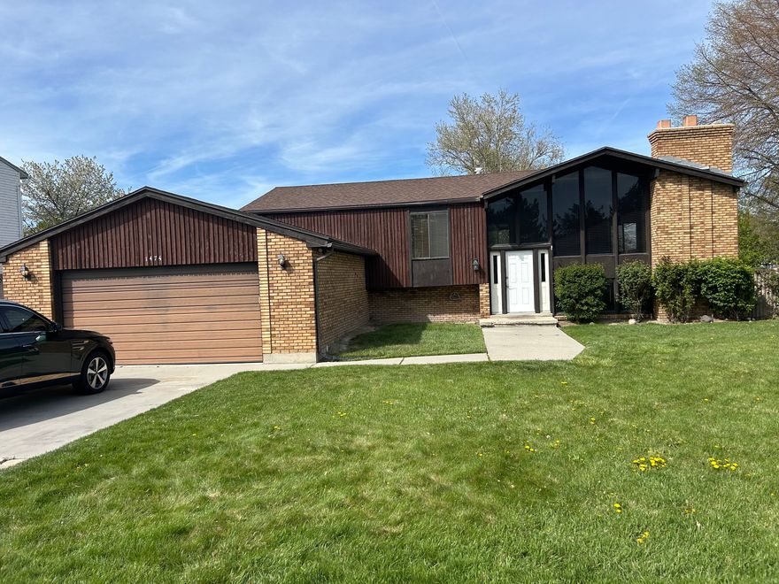 Want a great house in a great neighborhood?.  This 4-bedroom 2-bath home has a great floor plan with huge picture windows in the living room, a fireplace, an eat-in kitchen, and a basement that has been plumbed for a bathroom and is ready for your personal touches to design and make the basement area just how you want it.  There is a deck off the Kitchen for your BBQ area.  Big yard with beautiful seasoned rose bushes and an oversized 2 car garage.This one is going to sell quickly; bring all offers.