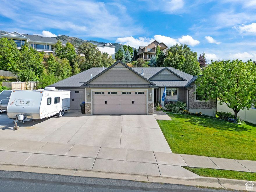 LOCATION LOCATION LOCATION!!! Stunning Home on the Providence Bench, Sought-After Location  Discover this exceptional home located on the highly desirable Providence Bench, nestled IN a quiet dead-end street. This residence has been immaculately maintained and offers both comfort and functionality in one of Cache Valley's most sought-after neighborhoods.  Highlights include:  Impressive 3 Car Garage, spacious and versatile, perfect for vehicles, storage, or a workshop.  Dedicated 36 foot RV Parking, additional space to accommodate an RV, boat, or trailer.  Beautifully Landscaped Grounds, fully finished yard with established trees, shrubs, and lawn, designed for easy enjoyment and curb appeal.  Pride of Ownership, meticulously cared for inside and out, move-in ready condition.  This home combines privacy, convenience, and style in a premier location with breathtaking surroundings. Properties in this neighborhood are rarely available-don't miss the chance to make it yours! Priced below recent appraisal.