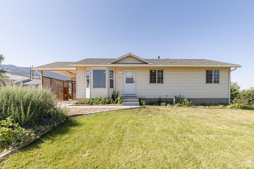 Charming Enoch starter home with horse property on 1/2 acre! Move in ready 3-bed, 2-bath with 1,537 sq. ft. of living space on a 1/2 lot. Features include updated flooring, ceiling fans, modern kitchen with all major appliances included. Upgraded bidet toilets, & a laundry chute in the primary closet. Enjoy fruit trees, lilacs , there is a dog run or make this area your garden. There is a horse-ready setup with corral. YES you have animal rights! Bonus basement family room, powered workshop, shed, conex container, newer roof, central air/heat, auto sprinklers & a covered carport. Peaceful, year round access neighborhood-ideal for homesteading or just room to breathe!