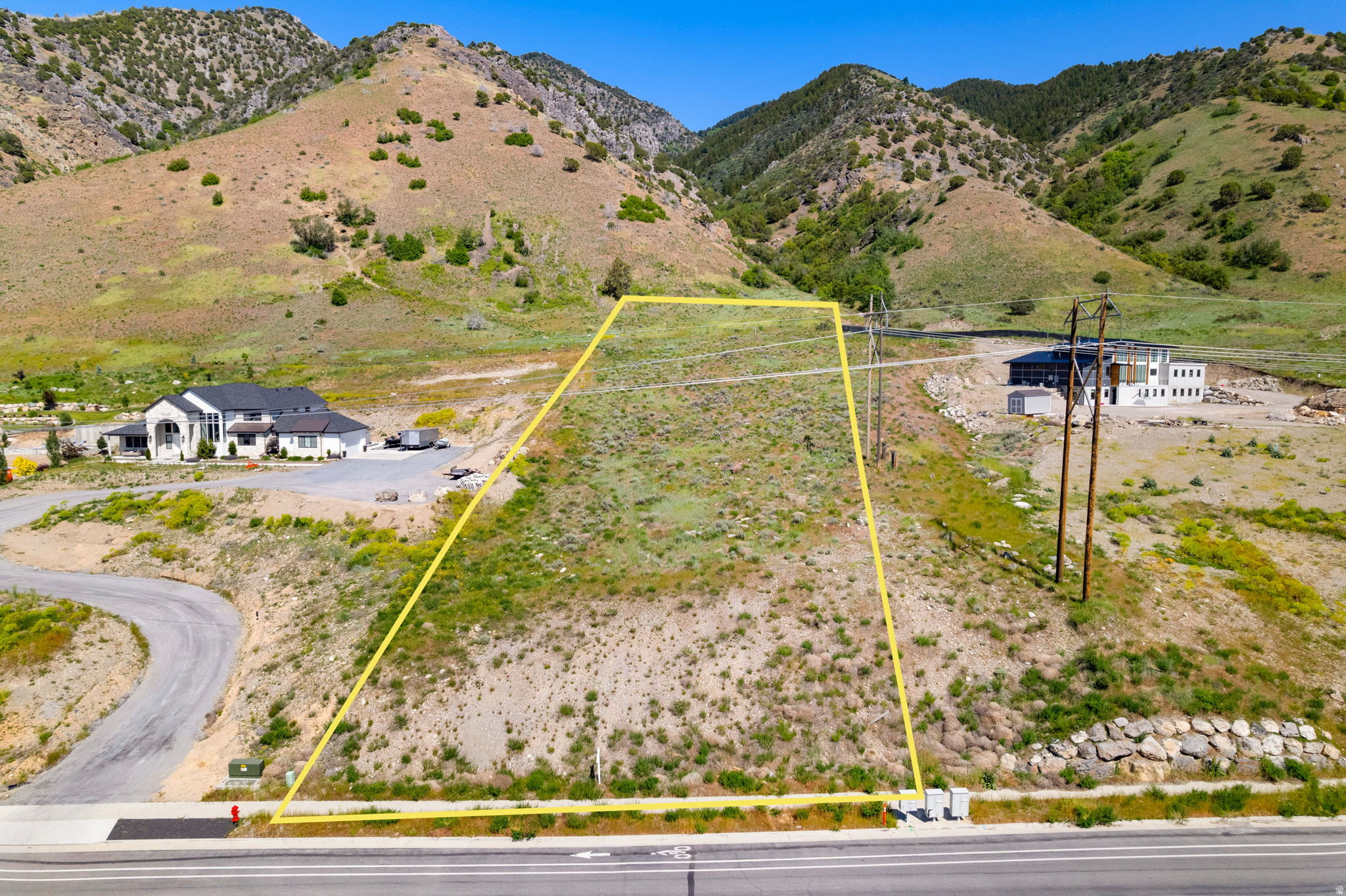 Expansive undeveloped lot featuring natural vegetation and a mountainous backdrop