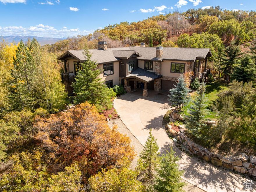 Welcome to Luxury, Comfort and Convenience in this Meticulously constructed Stone and Stucco estate  featuring great room concept with soaring vaulted ceilings, Chef's kitchen.  Spa- inspired Primary Suite with Fireplace, jetted tub, steam shower and private balcony. 3 additional bedrooms, 2 Offices, 4 bathrooms, gym, and a Family room. Granite Counter Tops. Hardwood, Slate and carpet floor coverings. Elevator, heated driveway, 3-car oversized heated garage. Pella triple pane windows. Beautiful private yard expansive views. This home blends timeless elegance with modern amenities perfect for discerning buyers seeking luxury, privacy, and comfort.