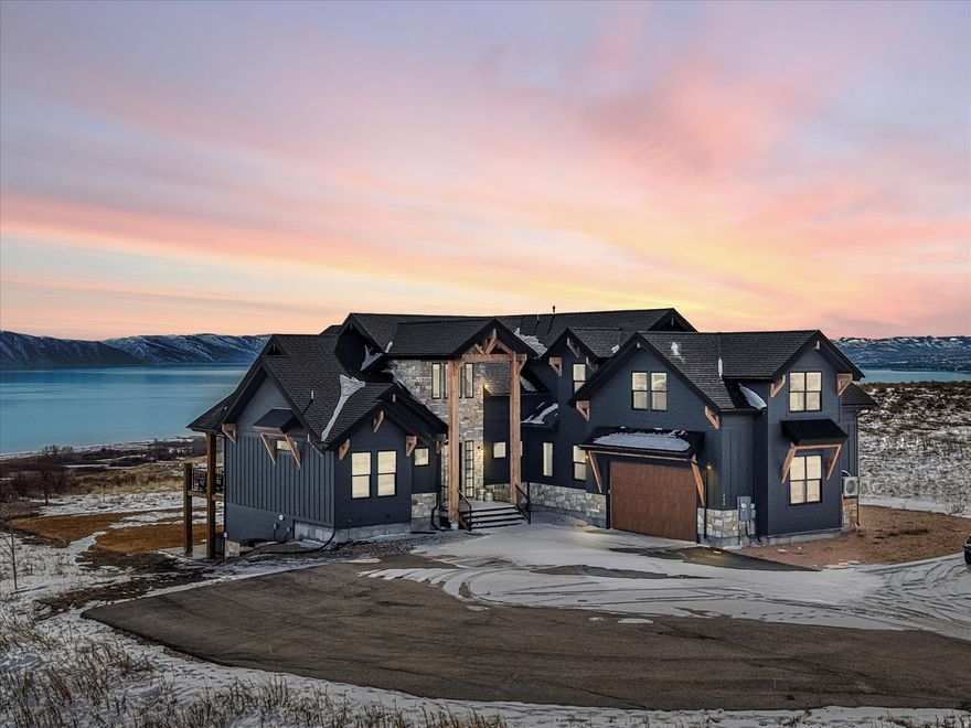 Experience elevated mountain living in this stunning 6-bedroom, 6-bathroom home in The Reserve, offering an impressive 5,990 sq ft of thoughtfully designed space. Situated on an oversized lot with sweeping views of Bear Lake from one end to the other, this property delivers both privacy and breathtaking scenery. Built for entertaining and relaxation, the home showcases high-end finishes throughout and is being sold fully furnished, making it completely turn-key and ready to enjoy or rent immediately after closing. With bookings already in place for 2026, this is an exceptional short-term rental investment opportunity. The expansive chef's kitchen is fully equipped and designed to host, featuring generous counter space, premium appliances, and everything needed to gather and entertain with ease. Multiple living areas on every level provide plenty of room for activities and large groups. Entertainment is a standout feature. The garage has been transformed into an incredible gaming room complete with four TVs and gaming consoles, while a private movie theater includes reclining sofas, a wall projector, and surround sound for an immersive experience. Owners in The Reserve also enjoy access to a private beach, adding to the exclusive lifestyle this community offers. Whether you're seeking a luxury retreat, income-producing property, or both, this home checks every box.