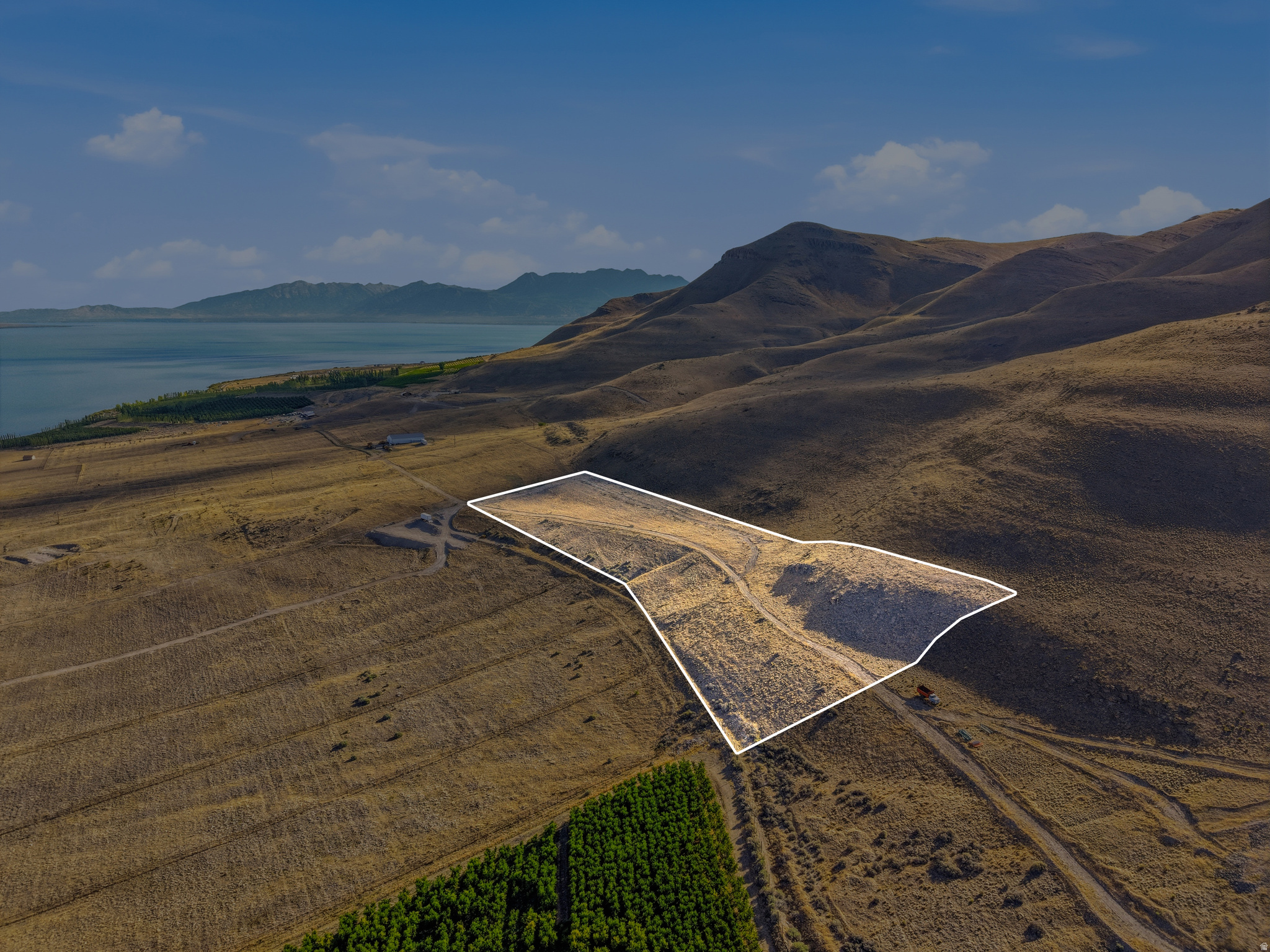 Expansive land parcel featuring natural terrain and distant water