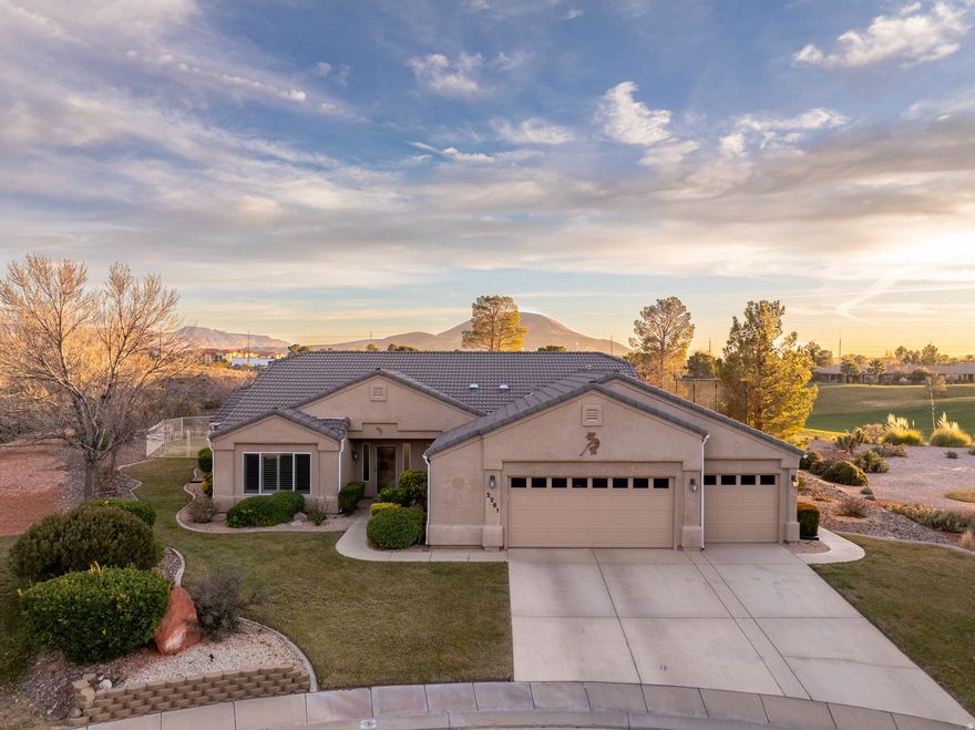 Welcome to this beautifully maintained home backing directly to the Sky Mountain Golf Course, offering sweeping views of hole #15 and the surrounding red rock landscape. The thoughtfully designed, open floor plan features vaulted ceilings throughout and spacious living areas filled with natural light from southern-facing windows and a covered patio. The extra-large kitchen is ideal for entertaining, complete with a generous island, distinctive granite countertops, two skylights, and a walk-in pantry. Recent updates include new luxury vinyl plank flooring in the living room, dining area, and primary bedroom, along with updated door hardware and hinges throughout. The primary suite is a private retreat with vaulted ceilings, distinctive fireplace, a soaking tub, and a large walk-in shower. A versatile den provides flexible space for a home office or additional living area. Situated on a generous 0.44-acre lot, the fully fenced backyard is perfect for relaxing or entertaining, featuring a built-in BBQ. The extra-deep 3-car garage offers ample space for vehicles, storage, and a workshop. Residents enjoy access to community amenities including a pool, hot tub, clubhouse, gym, and discounted greens fees.