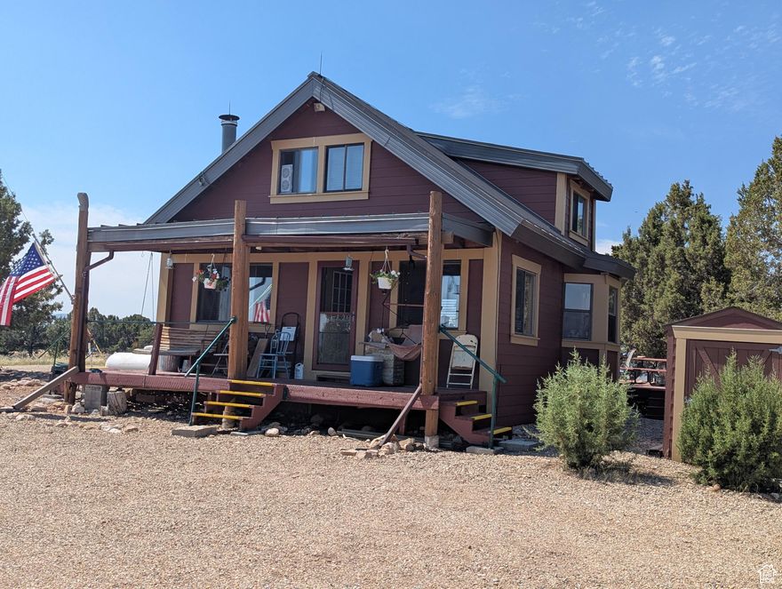 Must see the view from this custom built cabin in Bandanna Ranch overlooking the airstrip! This cabin would make the perfect getaway or full time residence. It is fully furnished, including a shed with all the tools you need for maintenance! Year round access in a beautifully wooded area. Lots of trees and fantastic views all around.