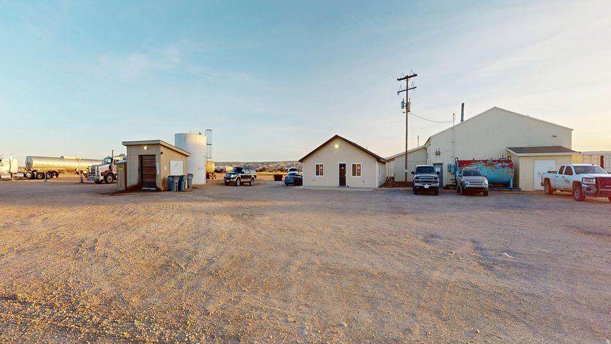 Prime 9-acre fully fenced commercial property! Office building with 2 private offices, bathroom, conference room, and  small kitchen. 5000sqft shop with heat, bathroom, and storage rooms. 2 Connex storage containers. Fuel tank & pump system.