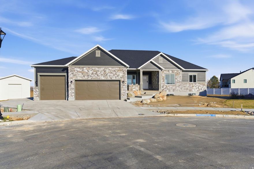 Exceptional luxury spec home in a sold-out community, available now with the rare opportunity to personalize final finishes. Buyers may select countertops, appliances, and flooring for bedrooms and stairs-enjoying a custom touch without the wait of a full build. Abundant natural light fills the home, highlighting high-end finishes throughout, while the walk-out basement is plumbed and ready for a potential ADU or mother-in-law apartment. Tucked into a quiet cul-de-sac on a large, premium lot, the home captures beautiful mountain views and offers convenient access to the West Davis Corridor (SR-177). Expansive living spaces and a four-car garage provide exceptional flexibility for vehicles, storage, or RVs. Modern design, energy-efficient systems, and builder warranties deliver refined, low-maintenance living in an established, completed community.