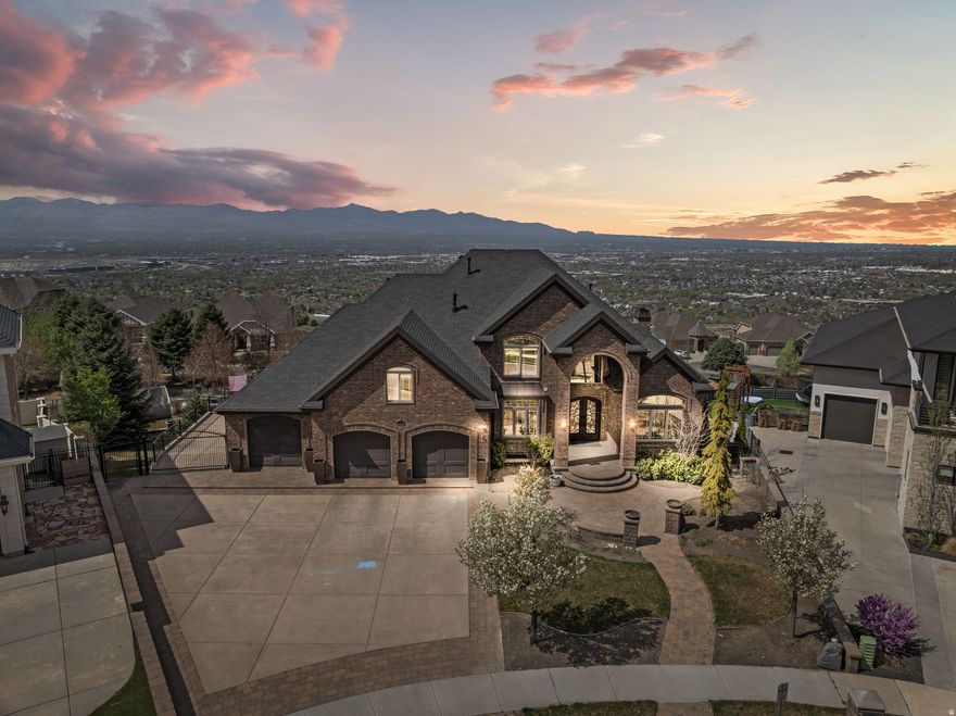 Perched above Draper with unobstructed valley views that stretch for miles, this 8,047 sqft estate delivers the rare combination of luxury living and outdoor access that defines Utah's best properties. Steps from Corner Canyon's trail network and the Draper Temple, this home sits where convenience meets wilderness.  The main level flows with intention: chef's kitchen anchoring daily life, living spaces designed for both entertaining and quiet evenings watching the city lights below. A fully finished basement apartment provides flexibility for multi generational living, guest quarters, or rental income potential.  The backyard rivals any resort: in ground trampoline, custom gazebo, working greenhouse for year round gardening, swingset, and a hot tub positioned for those valley views. Movie room built for actual movie nights. Every detail considered for families who want it all: space, privacy, adventure access, and a home that works as hard as you do.  This isn't just square footage. It's a lifestyle property for buyers who understand the value of waking up to trails at your doorstep and coming home to a backyard your kids will remember forever.