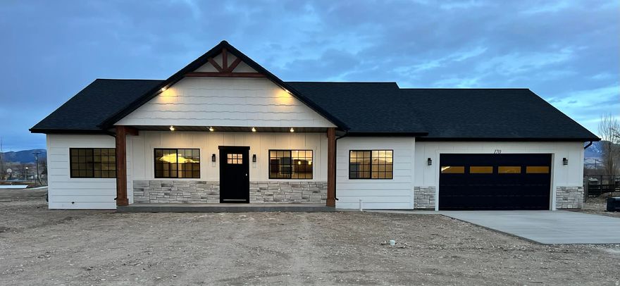 Brand New Construction  Just Completed March 2026! This modern farmhouse-style home is timeless with fresh, clean finishes. The exterior features durable cement board siding, stone accents, and sleek black shingles. Inside, you'll find a bright, open layout with stone countertops in the kitchen. The 3-bedroom, 2-bath layout includes a spacious primary bedroom with a walk-in closet and private shower. Additional features include a dedicated laundry room with butcher-block counter-tops, on-demand water heater, and water softener. Whether you're working with a buyer's agent or not, don't wait-call or text today to schedule your private showing! Schedule showings through the Aligned Showings app, or text/call.