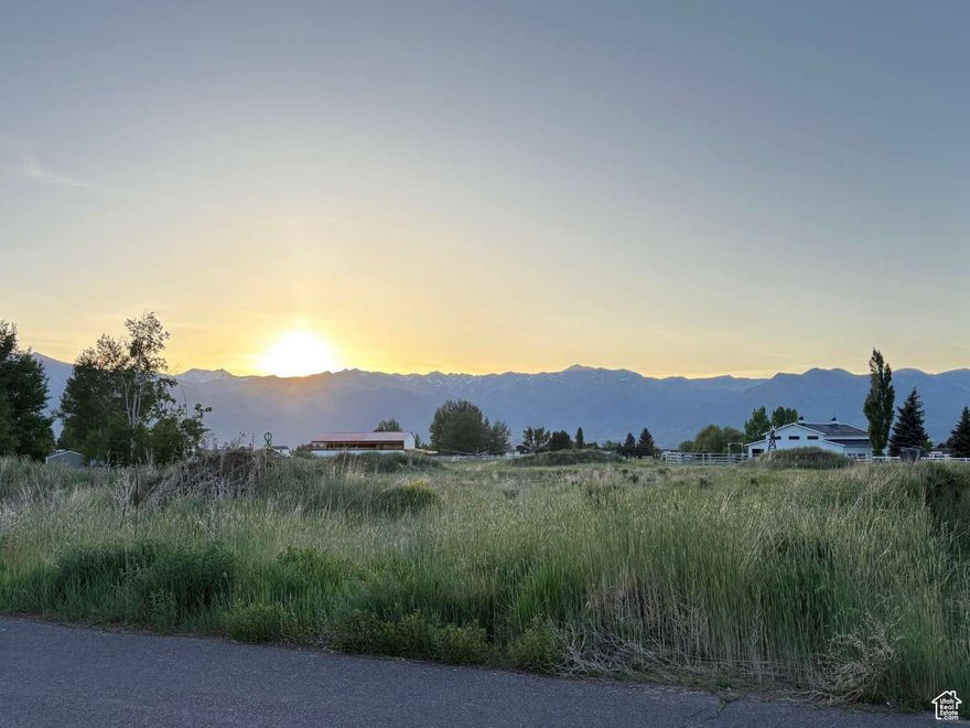 MUST SEE 2+ acre lot in rural Heber. Animals welcome. Sunsets over Timpanogas. Amazing neighbors. NO HOA Fees or crazy building rules. Quiet neighborhood with NO traffic running through it. Quick access to the highway. Includes 2 water shares and is ready to build on! This property has amazing neighbors on all 3 sides of it. As you can see from the Google map image, I had plowed a driveway along one side of the property to go to the back of the property and filled it in with road base. The topsoil was scraped and placed in a couple of piles on the property for use in the future yard.  When we purchased the property it did not have water shares with it. By the time we were able to track them down, we had purchased a different lot and drew up plans. If you are looking for a quiet country neighborhood without being far from town, THIS is the place!