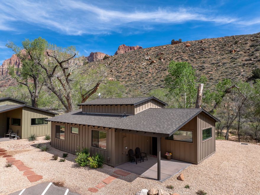 Rare riverfront opportunity in the heart of Springdale, just minutes from Zion National Park!  Tucked along the scenic Virgin River & surrounded by towering red rock cliffs, this beautifully designed home is located within the intimate Canyon Cottonwood Cottages community-comprised of only 9 residences, with just 3 offering coveted riverfront positioning... and this is one of them! Thoughtfully designed with clean, modern finishes, this 2-bedroom, 2-bath home offers approximately 1,400 sq ft of total living space, including a versatile loft-ideal for additional sleeping space, a home office, or a cozy retreat. Expansive windows frame breathtaking views of Zion's iconic landscape, bringing the outdoors in and creating a light, airy feel throughout. The open-concept living area flows seamlessly into a well-appointed kitchen featuring sleek cabinetry, quartz countertops, & stainless appliances. Step outside & enjoy direct access to the Virgin River, w/peaceful surroundings perfect for unwinding after a day of hiking or biking. Ideally located on the south end of Springdale, you're just moments from Zion National Park, world-class hiking & biking trails, boutique shops, art galleries, and some of the area's most sought-after dining. Whether you're searching for a private getaway, investment opportunity, or full-time residence, this is a truly exceptional opportunity in one of Southern Utah's most iconic settings. County records may not reflect the additional approximately 300 sq ft loft space. Buyer to verify all information, including square footage.