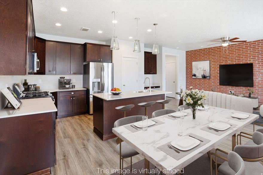 This beautifully maintained townhome has a functional layout that maximizes space for everyday living. The open-concept ground floor features a lovely light-filled kitchen with wood cabinetry and stainless steel appliances. The kitchen features a large French door fridge and a dishwasher less than a year old. Upstairs there is a spacious landing with a laundry room (washer and dryer included) conveniently located near all three bedrooms. The principal bedroom suite features a giant double-sized bedroom with a view of the Wasatch front, a large walk in closet and a bathroom with shower and double sinks. The two secondary bedrooms are spacious, and one has double doors which make it ideal for a home office. The two car garage offers abundant storage space and opens facing the community pool behind the home. The home is well located to enjoy the amenities of Daybreak, including the long greenbelt and walking/biking path just steps from the front door.