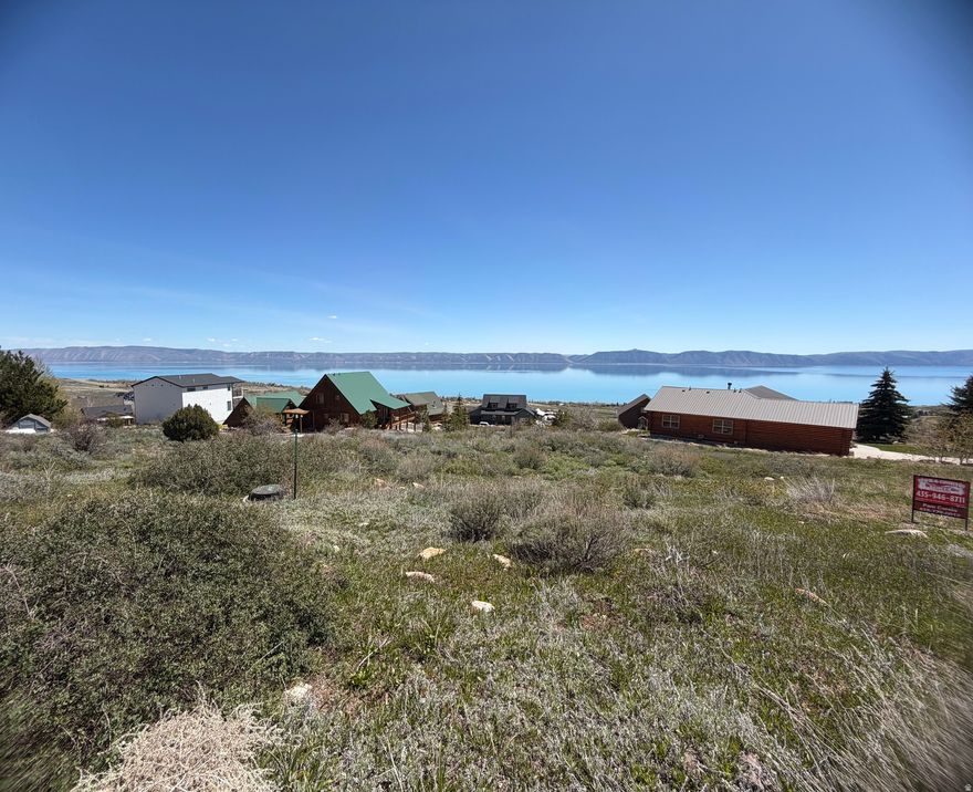 What an amazing view of Bear Lake, the valley and mountains. The fall colors are always breath taking . When you complete your dream home you can sit on your deck and watch the sunrise while you enjoy breakfast at your happy place. Bear Lake has always provided opportunities  for relaxation, water adventures whether you enjoy fishing or boating, water skiing.  Make this lot your landing spot.
