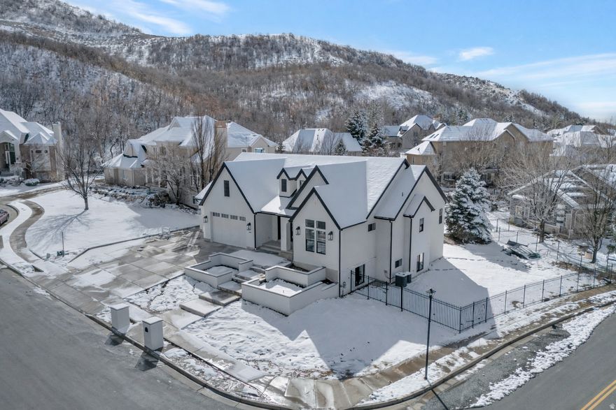Rare opportunity for a brand new custom home located in the highly sought-after Eaglewood Cove community in North Salt Lake. This stunning rambler offers refined living with exceptional craftsmanship and interior design throughout. Nestled on a .36-acre lot in a cul-de-sac against the mountain backdrop and next to a golf course, this home combines privacy, elegance, and convenience - all within 10 minutes of I-15 access and only 15 minutes from downtown SLC. Designed with both everyday living and entertaining in mind, the gourmet kitchen is a true showpiece featuring a massive island, 48" range, decorative built-in refrigerator and freezer, expanded pantry with scullery, and an oversized dining nook ideal for hosting. Custom built-ins and detailed finish work elevate every space. The luxurious primary suite boasts vaulted ceilings with decorative beams and a spa-inspired bathroom retreat. The fully finished walkout basement provides generous additional living and entertaining space. Car enthusiasts and hobbyists will appreciate the oversized 3-car garage, including a rare 43' deep third bay. Located near multiple golf courses, parks, and hiking trails, this home offers mountain living with city convenience. A rare opportunity to own a truly exceptional custom home in one of North Salt Lake's most desirable communities. Price includes full landscaping which will commence when weather allows.