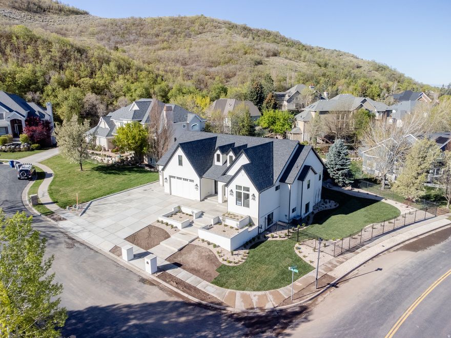 Rare opportunity for a brand new custom home located in the highly sought-after Eaglewood Cove community in North Salt Lake. This stunning rambler offers refined living with exceptional craftsmanship and interior design throughout. Nestled on a .36-acre lot in a cul-de-sac against the mountain backdrop and next to a golf course, this home combines privacy, elegance, and convenience - all within 10 minutes of I-15 access and only 15 minutes from downtown SLC. Designed with both everyday living and entertaining in mind, the gourmet kitchen is a true showpiece featuring a massive island, 48" range, decorative built-in refrigerator and freezer, expanded pantry with scullery, and an oversized dining nook ideal for hosting. Custom built-ins and detailed finish work elevate every space. The luxurious primary suite boasts vaulted ceilings with decorative beams and a spa-inspired bathroom retreat. The fully finished walkout basement provides generous additional living and entertaining space. Car enthusiasts and hobbyists will appreciate the oversized 3-car garage, including a rare 43' deep third bay. Located near multiple golf courses, parks, and hiking trails, this home offers mountain living with city convenience. A rare opportunity to own a truly exceptional custom home in one of North Salt Lake's most desirable communities.