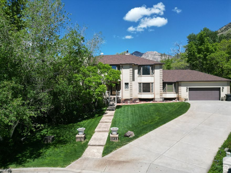 Nestled on over 2 acres of picturesque land, this charming home combines nature, comfort and luxury to create a truly remarkable living experience.  As you enter, you'll be greeted by a timeless foyer with a grand staircase that leads to the library/sitting area, primary suite, 3 additional bedrooms and a bathroom. The spacious layout of the main level offers plenty of room for entertaining or daily living. Downstairs offers additional bedrooms, storage and a movie theater. This unique property offers endless possibilities, all within a serene, private setting.