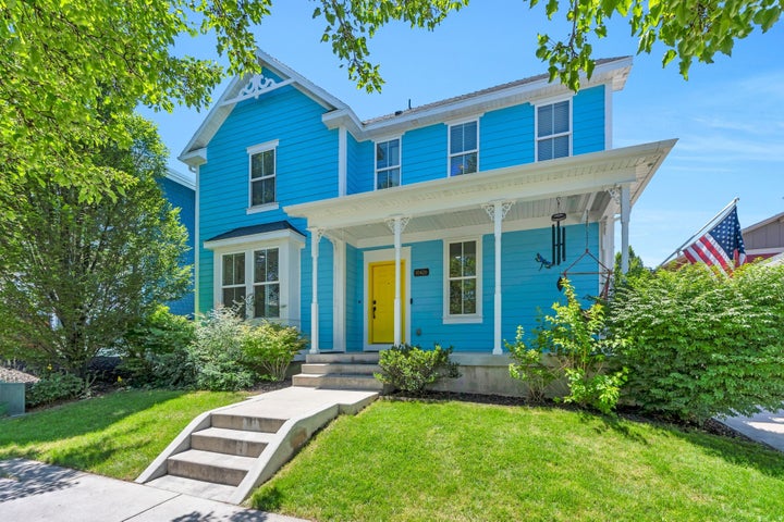 Vibrant blue exterior with a welcoming yellow front door