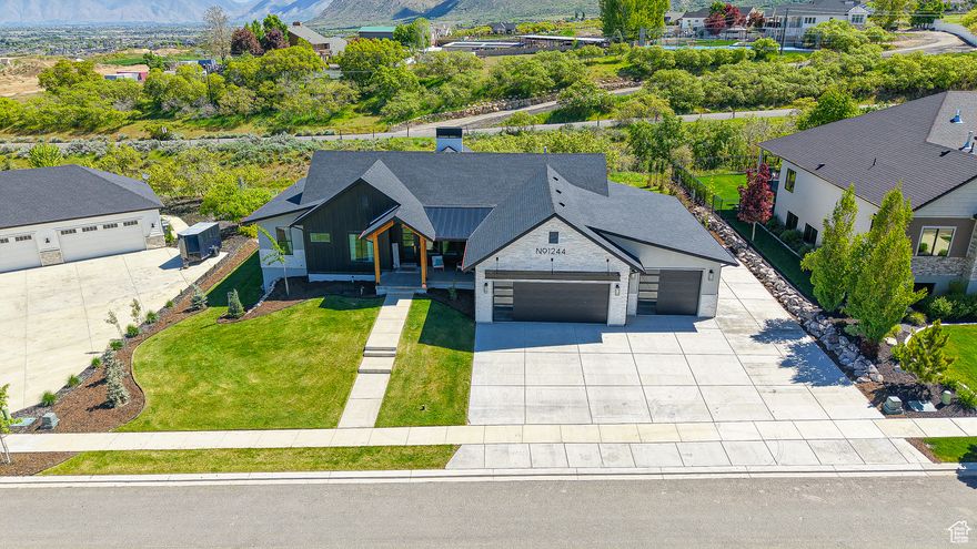 Be sure to click on the tour button to see the 3D and first person fly through tours. This stunning, fully custom, mountain-modern home is a must-see, nestled in the highly sought-after Premier Point neighborhood. Designed with a blend of contemporary elegance and functionality, it boasts top-tier finishes and architectural details throughout. Features and upgrades include numerous floor to ceiling windows, modern cabinetry, quartz countertops, double ovens with a separate cooktop, vented hood, LVP throughout, custom modern railings, 9ft ceilings on the main and basement, double sided fireplace, motorized shades, large shower with double shower heads, separate tub, double vanities, spacious walk-in-closet, jack and Jill bath, large butlers pantry, large covered deck, vaulted ceilings and recessed lighting throughout. An office off the kitchen features large windows that provides a bright, inspiring workspace, offering panoramic views and its own private patio. Spacious five car garage with added RV parking and a 240v outlet.The home is very energy efficient with a tankless water heater, high efficient furnace, and a water softener. The exquisite exterior boasts a mountain modern elevation, some metal roofing and front porch timbers. Perfect orientation with a west facing driveway that receives plenty of sun and an east facing deck for plenty of shade in the afternoons. The yard is fully finished to allow for enjoyment of the incredible views of the mountains, valley and natural trees located on the property. The walk-out basement is plumbed for a future kitchenette, has a large cold storage, and the framing has already been completed. This home is truly a masterpiece of design and functionality, combining luxurious living with modern efficiency. Perfectly suited for those who appreciate both style and sustainability, it offers everything you need for a high-end lifestyle.