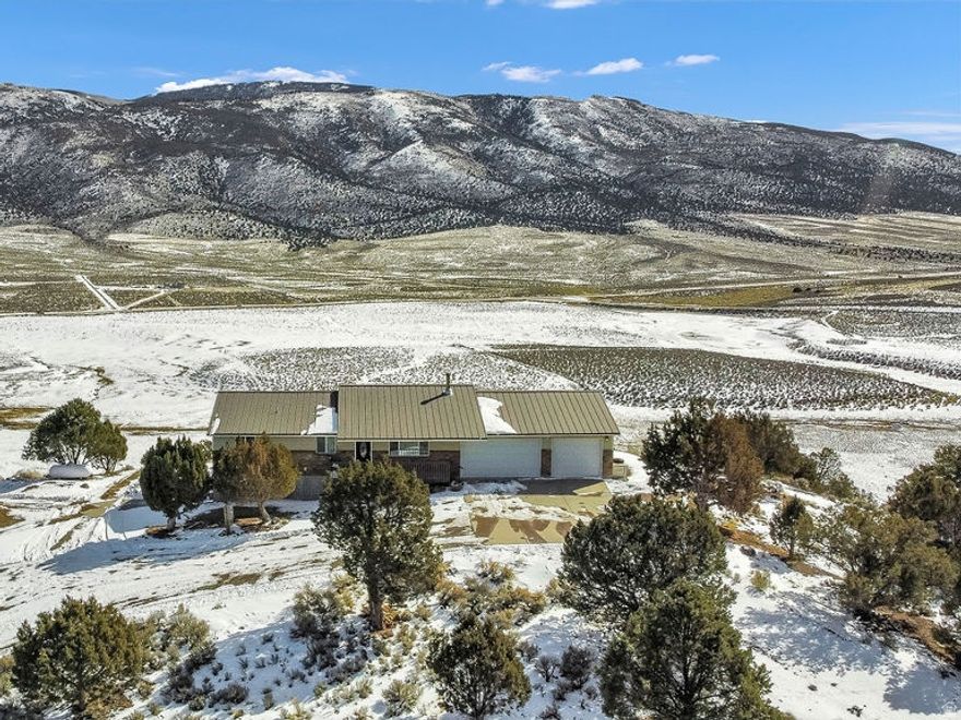 If you want views that truly stop you in your tracks, this is the place.  Set on the east side of Burrville Hill overlooking Koosharem Reservoir, this 4-bedroom, 3-bath home rests on 20.00 acres of open ground and big Utah sky. The setting alone is hard to beat - quiet, private, and perfectly positioned to capture those unforgettable east-facing sunrises rising over the water.  Inside, you'll find a well-appointed kitchen, warm and inviting living spaces, and a wood-burning fireplace that makes winter evenings feel exactly the way they should. Propane heat keeps the home comfortable year-round.  Step onto the east-facing deck and you'll immediately understand what makes this property special - wide open views, fresh air, and room to breathe.  The home offers a 2-car attached garage plus a large detached garage, providing ample space for vehicles, recreational toys, storage, or a workshop. A dedicated game room adds flexibility and includes a Murphy bed, making it ideal for additional guests or multi-purpose use.  Whether you're looking for a full-time residence, a secondary home, or a private retreat, this property offers the rare combination of acreage, privacy, functionality, and truly unforgettable views - all in one remarkable location.