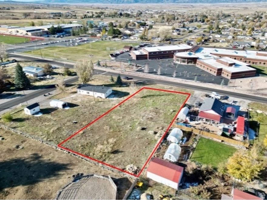 Prime .44-Acre lot within City Limits! Build your dream home on this spacious and relatively flat .44-acre lot, ideally located just steps from both the elementary and high school. Enjoy the convenience of in-town living with the added bonus of beautiful mountain views. With utilities nearby and ready-to-build potential, this property offers the perfect blend of location, space, and scenic surroundings. Don't miss this rare opportunity! Pressurized Irrigation is stubbed on the lot. All information within is provided as a courtesy only. Buyer and Buyer's agent advised to complete their own due diligence. Property and lot lines are shown as approximate.