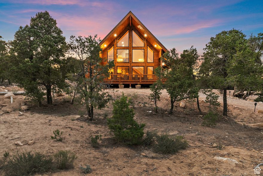 Privacy, independence, and craftsmanship define this 20-acre turnkey cabin west of Cedar City. Surrounded by juniper-studded high desert with sweeping views, it pairs luxury living with a self-sufficient utility stack: solar with battery storage and generator backup, private well, septic, and a deeded water right. Inside, vaulted ceilings and quality finishes frame an open layout with stone-counter kitchen, premium appliances, and wide porches for sunrise to stargazing. Two RV pads with full hookups expand hosting or income options, and high-speed internet keeps you connected. Offered furnished for immediate use, this retreat is ideal as a private sanctuary, second home, or luxury rental (buyer to verify local permits).