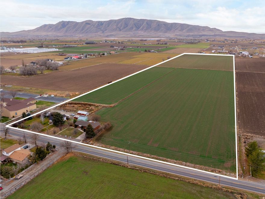 Rare 40-acre farmland opportunity in Spanish Fork with 2 homes and valuable water shares! Includes 40 shares Lake Shore Irrigation and 20 shares Strawberry water (.50 shares per acre). Main home offers 3 beds, 2 baths, office, ope n kitchen/family room with wood-burning fireplace, new flooring, new washer/dryer, newer roof, 2-car garage with cabinet shop, 100 amp service, 460' well and large storage tank; there's also another well. Second home sits on 6.83 acres, built in 1883/remodeled 1927, with new septic, 30-yr shingles, new plywood, newer furnace, and new pump. Est. rent $1,000/mo. Current renter is month-to-month and requires 2-month notice. The farmland is leased out until fall 2025. A unique chance for farm, animals, rental income or future development! Sale includes Parcel numbers #24-065-0030, #24-065-0024, #24-065-0020. Square footage figures are provided as a courtesy estimate only and were obtained from County Records . Buyer is advised to obtain an independent measurement.