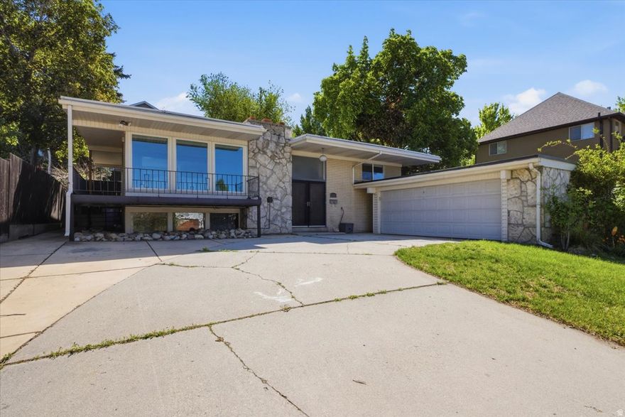 Welcome Home. Step inside this charming Cottonwood Heights gem. The moment you enter, you'll notice the bright and open newly updated Kitchen and Family Room, creating the perfect open-concept living space that truly serves as the heart of the home. The Kitchen has been thoughtfully updated with white cabinetry, Quartz countertops, stainless steel appliances, and stylish pendant lighting. Enjoy cozy evenings by the fireplace while cooking, entertaining, and gathering with family and friends. Built in 1965, this home blends inviting mid-century architecture with the modern updates today's buyers expect. Featuring 4 bedrooms, 3 bathrooms, and a fully finished basement, there is space for everyone to enjoy. The daylight walk-out basement with a spacious second Family Room with large picture windows, a second fireplace, providing flexible living options. Step outside and unwind in the private, lush backyard. The spacious patio, garden boxes, mature trees, and established landscaping create an exceptional outdoor retreat perfect for entertaining and everyday living. Ideally located just minutes from Big Cottonwood Canyon, world-class ski resorts, hiking and biking trails, shopping, dining, and highly regarded schools, this home offers the perfect combination of comfort, convenience, and access to outdoor lifestyle living.  Square footage figures are provided as a courtesy estimate only and were obtained from County .  Buyer is advised to obtain an independent measurement.