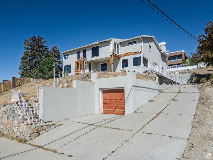 A rare Upper Avenues opportunity with unmatched views and flexible potential. The offering includes two parcels (Tax ID #09-30-479-007, 0.28 acres, and #09-30-478-015, 0.08 acres) totaling 0.36 acres. The existing home, partially demoed but structurally viable, can be renovated and expanded within its current footprint-or removed for a new custom build. Its grandfathered height offers a valuable advantage: by retaining one structural wall and foundation connection during construction, a buyer can preserve the existing height and footprint before new zoning limits and build-start timelines apply. Included: architectural plans, zoning Q&A, asbestos report, prior survey, and demolition bid (~$34,000). With extraordinary downtown and sunset views, minutes from the University and foothill trails, this is one of the most versatile redevelopment sites in the Upper Avenues.Property is sold as-is, where-is.